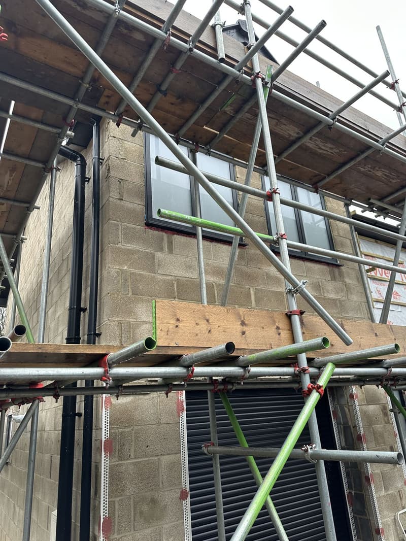 Ongoing: full transformation with extension, internal and external changes, cladding, picture window, black aluminium sliders and windows in Warsash, Southampton by Signature Design Architecture